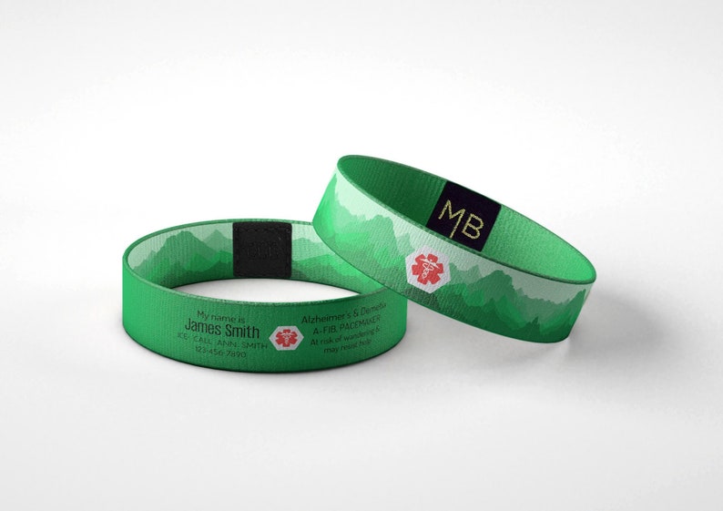 May include: Two green medical alert wristbands. One band displays the name "James Smith" and contact information. The other band has the initials "MB" and a medical symbol. Both bands feature a mountain design.