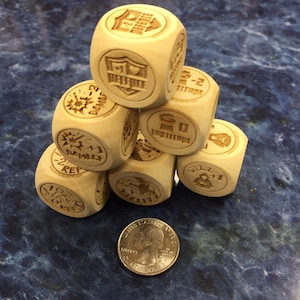 May include: A set of eight wooden dice with various symbols and text, including "Damage", "Rep", "Go", "Attitude", and "1-2". The dice are stacked in a pyramid shape on a blue surface.