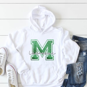 Custom Lacrosse any initial with Lacrosse written though it tees, sweatshirts, & hoodies.