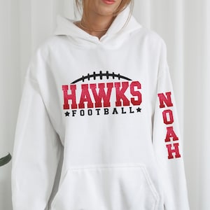 Personalized Bella Canvas Football spirit wear long sleeve tees and sweaters with name on sleeve and name and number on the back.