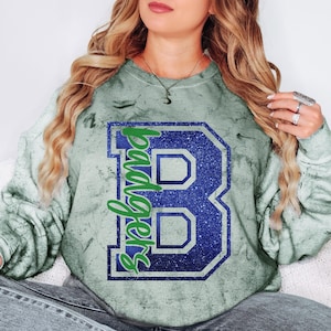 Custom Badgers Spirit Wear on Comfort Colors color blast t-shirts & sweatshirts with player name and number on the back.