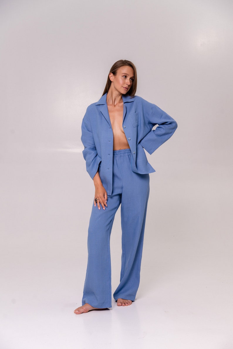 May include: A light blue linen pyjama set with a collared shirt and wide-leg trousers.