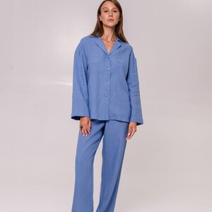 May include: A light blue pyjama set with a collared shirt and long trousers.