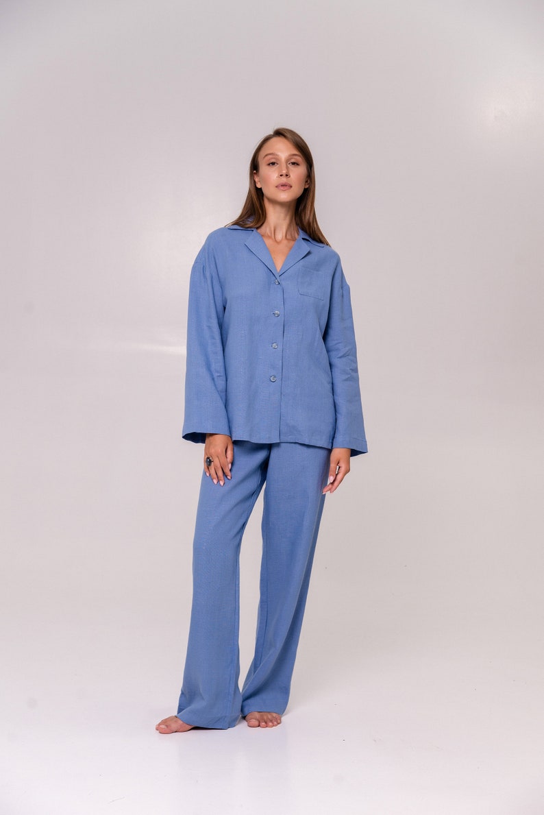 May include: A light blue pyjama set with a collared shirt and long trousers.