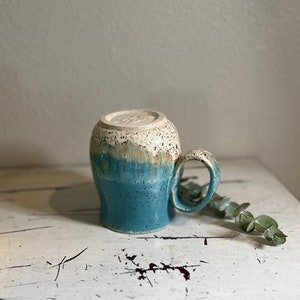 Beautiful handmade coffee mug made on pottery wheel glazed in robin’s egg blue with speckles
