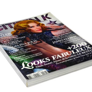 May include: A magazine cover featuring Angelina Jolie on the cover with the title "Looks Fabuleux" and the text "+200 Fabuleux: Le Best Of" in a white, black, and red color scheme.