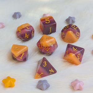 May include: Set of eight dice with a swirl pattern in shades of orange, purple, and pink. The dice are numbered 1 through 20.
