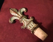 Vintage cast iron bottle stopper,wine,excellent condition,never used,measures 3 quot W 5.5 quot L 2.5 quot H