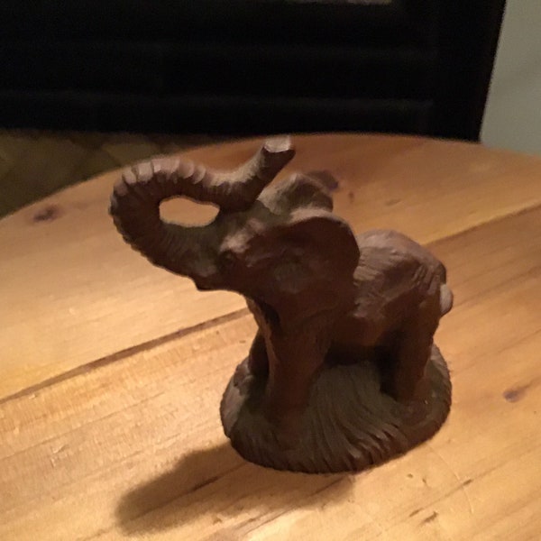 Little brown elephant with trunk raised for good luck made entirely out of pecan shells one of a kind