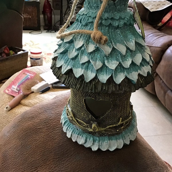 Beautiful blue birdhouse with green butterfly an heart shaped entrance,excellent cond,new,meas from hanger 12”H  base is 5x4.75” REDUCED