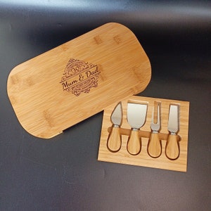 May include: A bamboo cheese board with a lid and four cheese knives. The board is engraved with the text "Congratulations Mum & Dad Est. 1991 30 Years Pearl Anniversary".