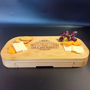May include: A bamboo cheese board with a drawer for storing crackers. The board is engraved with "Diamond Anniversary 60 Years" and "Mr. & Mrs. Roberts Est. 1963".