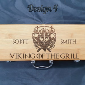 May include: A wooden grilling tool box with a Viking design and the text "SCOTT SMITH VIKING OF THE GRILL".