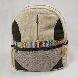May include: A beige hemp backpack with brown accents and a colorful woven band. The backpack has two zippered pockets on the front.