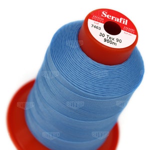 May include: A spool of light blue thread labeled "Serafil" with the brand name "Amann Group" and the details "Col 7463", "30 Tex 90", "900m", and "Lot no".