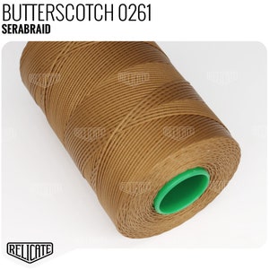 May include: A spool of brown waxed thread labeled "BUTTERSCOTCH 0261 SERABRAID".