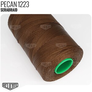 May include: A spool of brown waxed thread labeled "PECAN 1223 SERABRAID". The thread is wound around a green plastic bobbin.