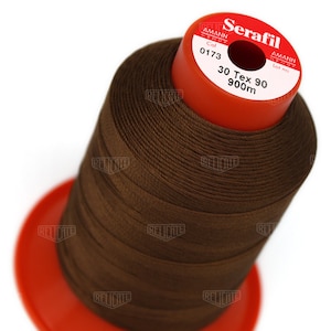 May include: A brown spool of Serafil thread with the text "Serafil", "Amann Group", "Col 0173", "Lot no", "30 Tex 90", and "900m" printed on the label.