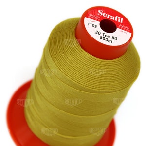 May include: A spool of yellow thread labeled "Serafil" with the text "30 Tex 90 900m" and "Col 1102" on the label.