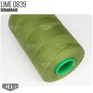 May include: A spool of lime green thread, labeled "LIME 0839 SERABRAID", is wound around a green plastic bobbin.