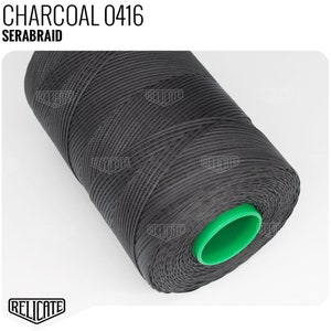 May include: A spool of charcoal colored thread with a green plastic center. The thread is labeled "SERABRAID CHARCOAL 0416".