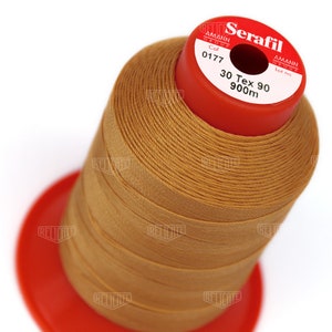 May include: A spool of brown thread labeled "Serafil" with the text "30 Tex 90 900m" and "Col 0177" on the label.