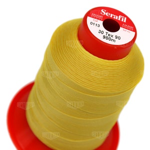 May include: A spool of yellow thread labeled "Serafil 30 Tex 90 900m" with the Amann Group logo and the color code "0113".