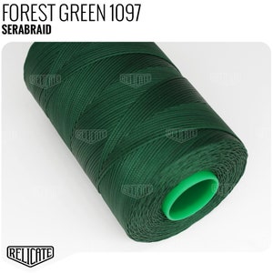 May include: A spool of forest green thread labeled "FOREST GREEN 1097" and "SERABRAID".