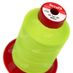 May include: A spool of bright yellow thread labeled "Serafil 30 Tex 90 900m" with the Amann Group logo and color code 1426.