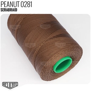 May include: A spool of brown thread labeled "PEANUT 0281 SERABRAID". The thread is wound around a green plastic bobbin.