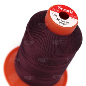 May include: A spool of dark burgundy thread labeled "Serafil" with the text "30 Tex 90 900m" and "Col 0788" on the label.