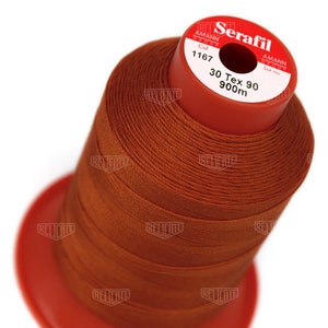 May include: A spool of orange thread labeled "Serafil" with the brand name "Amann Group" and the color number "1167". The spool also indicates the thread is "30 Tex 90" and "900m" long.