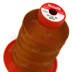 May include: A spool of brown thread labeled "Serafil" with the brand name "Amann Group" and the details "Col 0163 30 Tex 90 900m".
