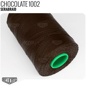 May include: A spool of brown waxed thread labeled "CHOCOLATE 1002 SERABRAID". The thread is wound around a green plastic bobbin.