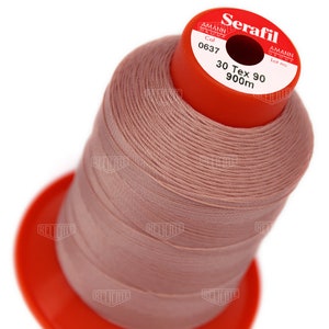 May include: A spool of pink thread labelled "Serafil" with the brand name "Amann Group" and the text "Col 0637 30 Tex 90 900m".