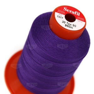 May include: A spool of purple thread labeled "Serafil" with the brand name "Amann Group" and the details "Col 7377", "30 Tex 90", and "900m".