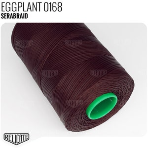 May include: A spool of dark brown thread with a green plastic end cap. The label on the spool reads "EGGPLANT 0168 SERABRAID".