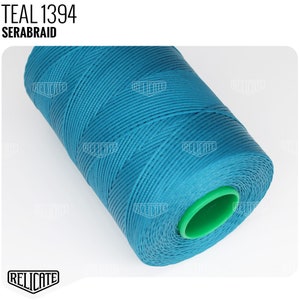 May include: Teal blue spool of Serabraid thread, labeled "TEAL 1394 SERABRAID".