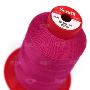 May include: A spool of pink thread labeled "Serafil" with the brand name "Amann Group" and the details "Col 8189 30 Tex 90 900m".