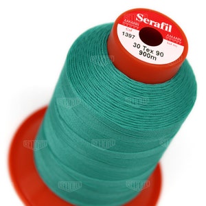 May include: A spool of teal green thread labeled "Serafil" with the brand name "Amann Group" and the text "Col 1397 30 Tex 90 900m".