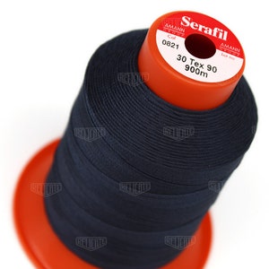May include: A spool of dark blue thread labeled "Serafil" with the brand name "Amann Group" and the text "Col 0821 30 Tex 90 900m".