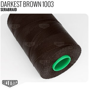 May include: A spool of dark brown SERABRAID thread, labeled "DARKEST BROWN 1003". The thread is tightly wound around a green core. The image is on a white background.