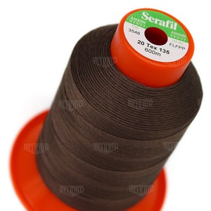 May include: A spool of brown thread labeled "Serafil" with the brand name "Amann Group" and the text "20 Tex 135 600m".