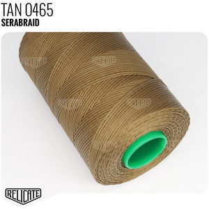 May include: A spool of tan colored waxed thread, labeled "TAN 0465 SERABRAID". The thread is wound around a green plastic spool.