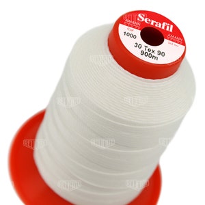 May include: A white spool of Serafil thread by Amann Group. The spool is labeled with the text "Serafil", "Amann Group", "Col 1000", "Lot no", "30 Tex 90", and "900m".