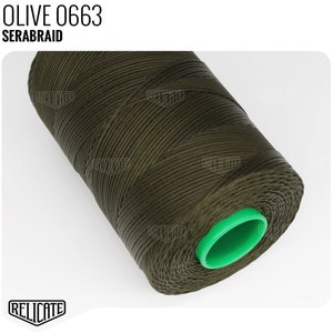 May include: A spool of olive green thread labeled "OLIVE 0663 SERABRAID". The thread is wound around a green plastic bobbin.