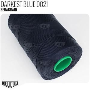 May include: A spool of dark blue thread, labeled "DARKEST BLUE 0821 SERABRAID".