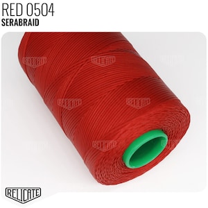 May include: A spool of red thread labeled "RED 0504 SERABRAID". The thread is wound around a green plastic bobbin.