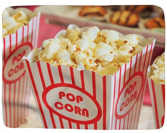 May include: Three red and white striped popcorn containers filled with popcorn. The containers have the words "Pop Corn" printed on them.
