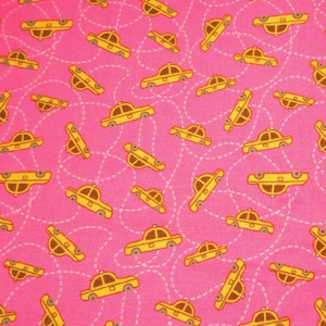 May include: A pink fabric with a repeating pattern of yellow taxi cabs. The cabs are outlined in white and have a black stripe on the side. The background is a solid pink color.